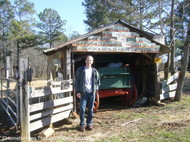 Randy_beside_license_plate_garage.JPG