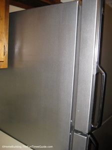 This photo shows how nice the side of the refrigerator looks after the entire process is complete and dry. old-fridge-painted-with-Thomas-liquid-stainless-steel-paint.JPG