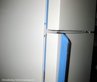 Use blue painter's tape to cover all parts you don't want to paint. tape-refrigerator-parts-not-to-be-painted.JPG