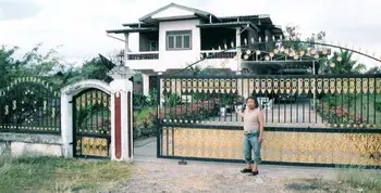 Sipaphay_in_front_of_her_home_in_Pakse_Laos.jpg