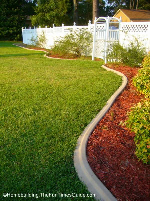 Curbing has the ability to direct you towards certain areas of your yard. In this case, an arbor leading to the backyard.