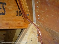 copper_nails_and_brackets_hold_cable_tight.JPG