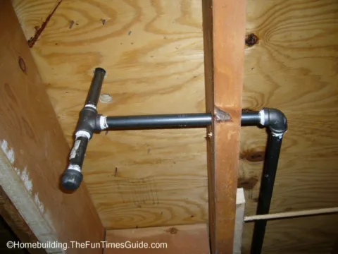 Cast iron gas pipes through floor joists with T-connect. 