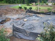 You can see the well cap in the middle of what amounts to a large puddle of granite dust mixed with water to form sort of a paste. A cleanup after the water well drilling is in order here to get the yard back in shape.