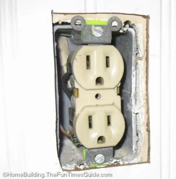 How do you install wall tile around electrical outlets?